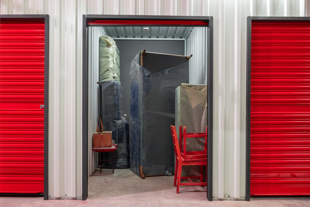 corridor of self storage unit with red doors. rental storage units